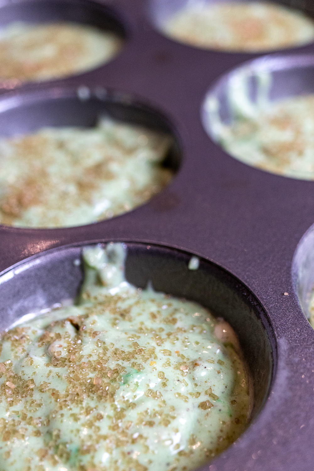 pistachio muffin batter in tin