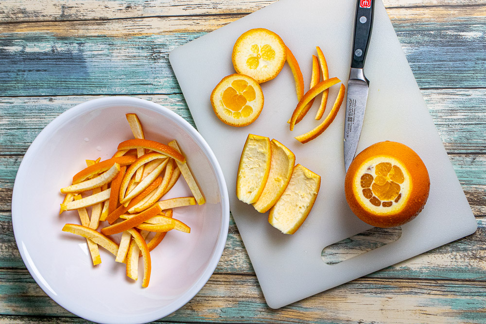 various stages of cutting an orange for candied peels