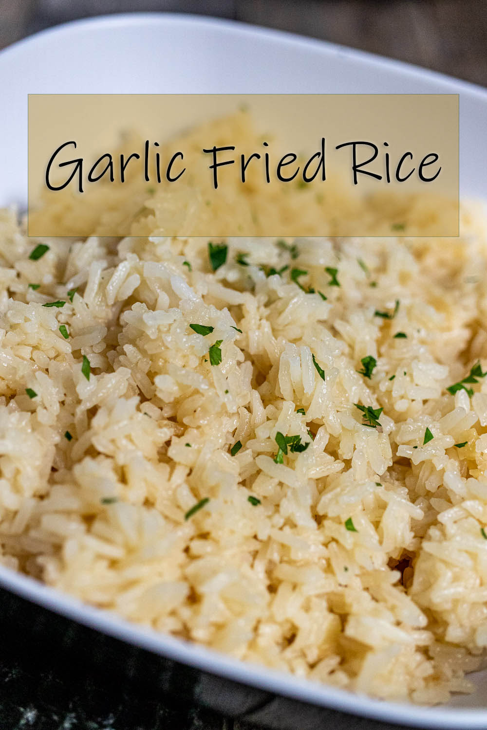 close up of garlic fried rice in a white bowl for Pinterest