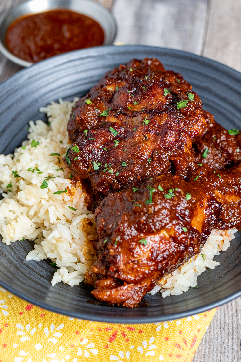 Mexican chicken adobo with rice on a black plate