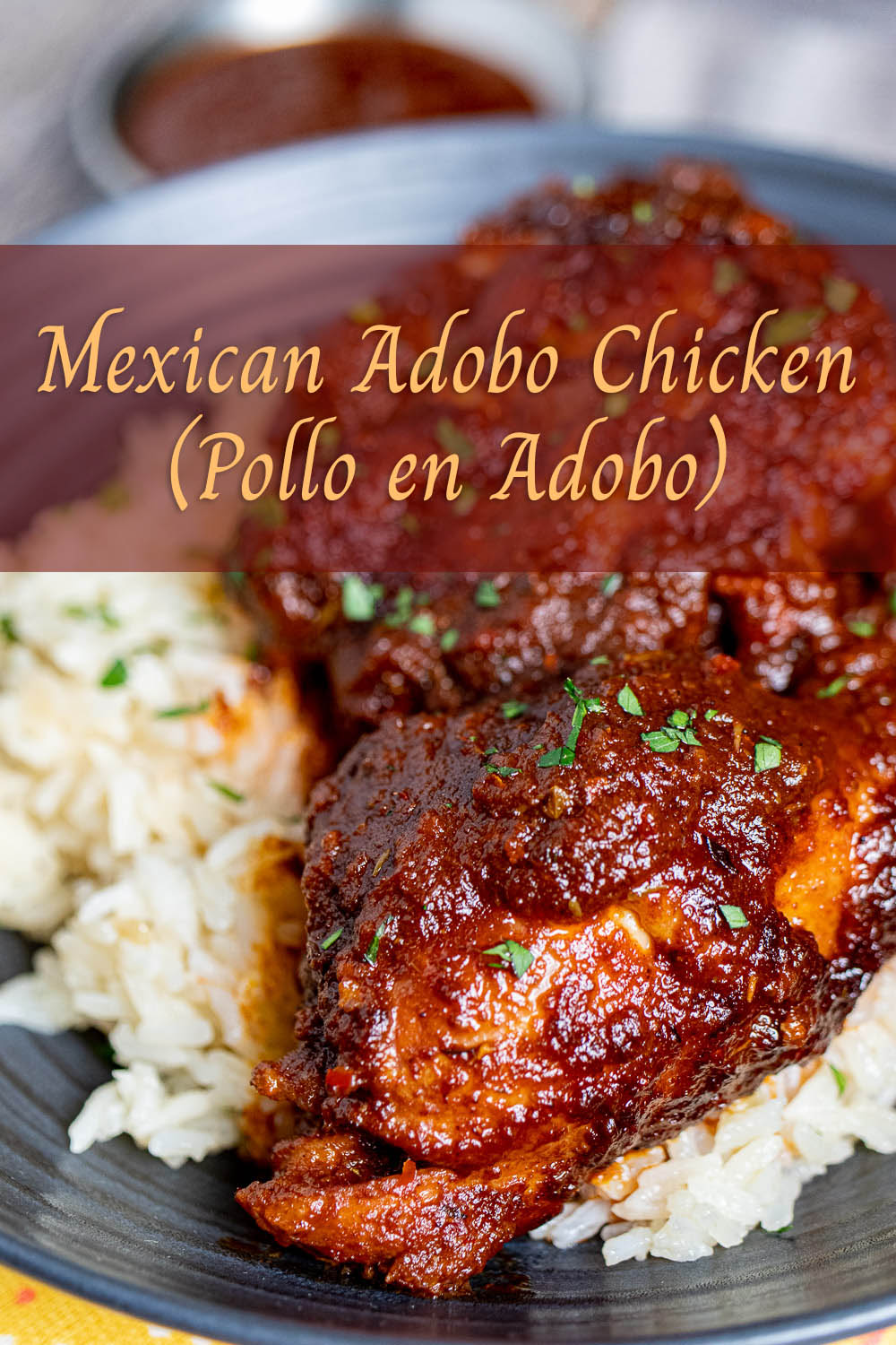 Mexican adobo chicken with rice on a black plate pinterest image