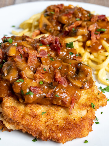 jagerschnitzel with spaetzle on a white plate