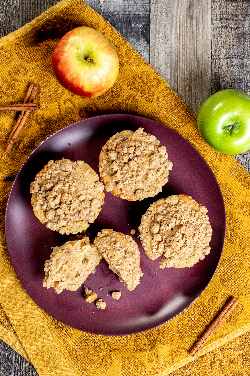 overhead view of cinnamon apple cider muffins on a red plate