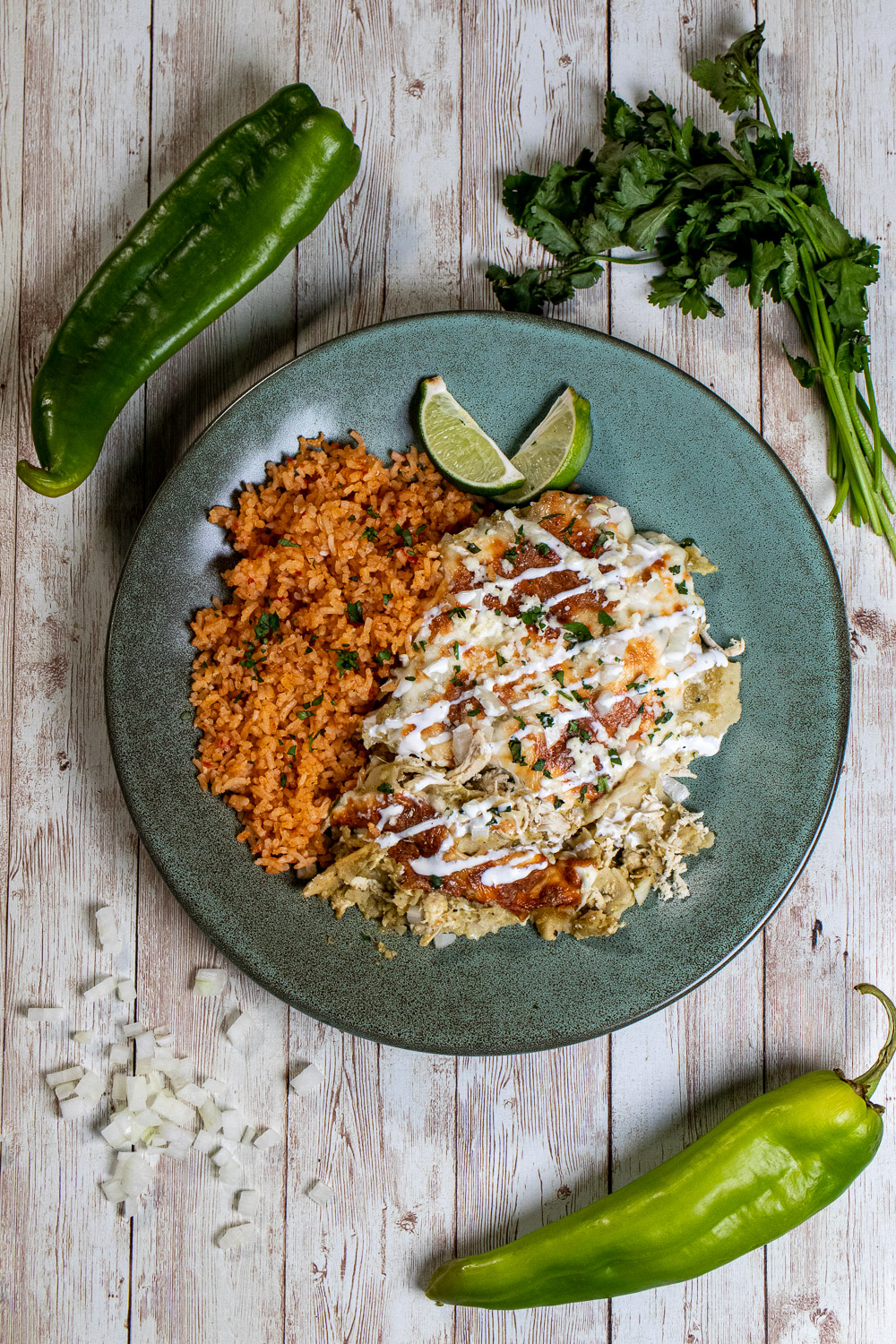 overhead view of Hatch green chile chicken enchiladas with Mexican rice