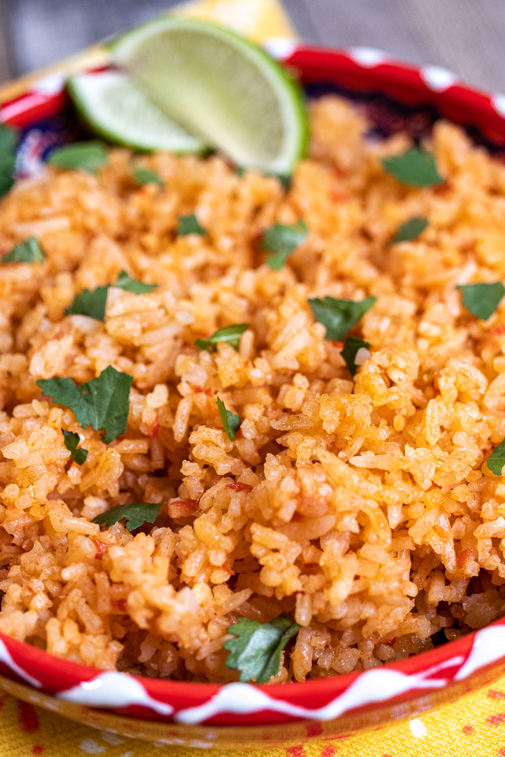 close up of Mexican rice in red and white bowl