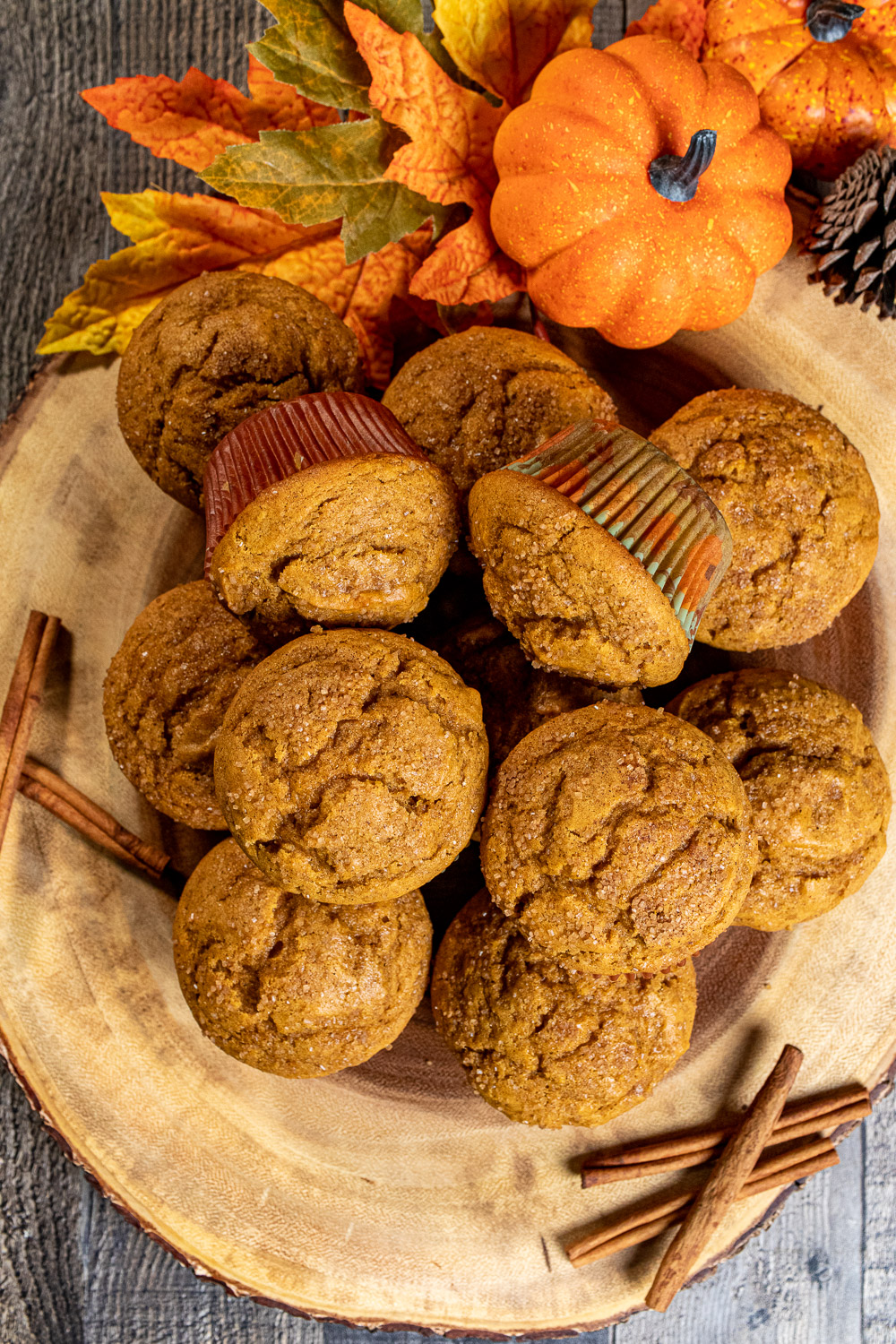 overhead view of pile of pumpkin spice muffins on wooden board