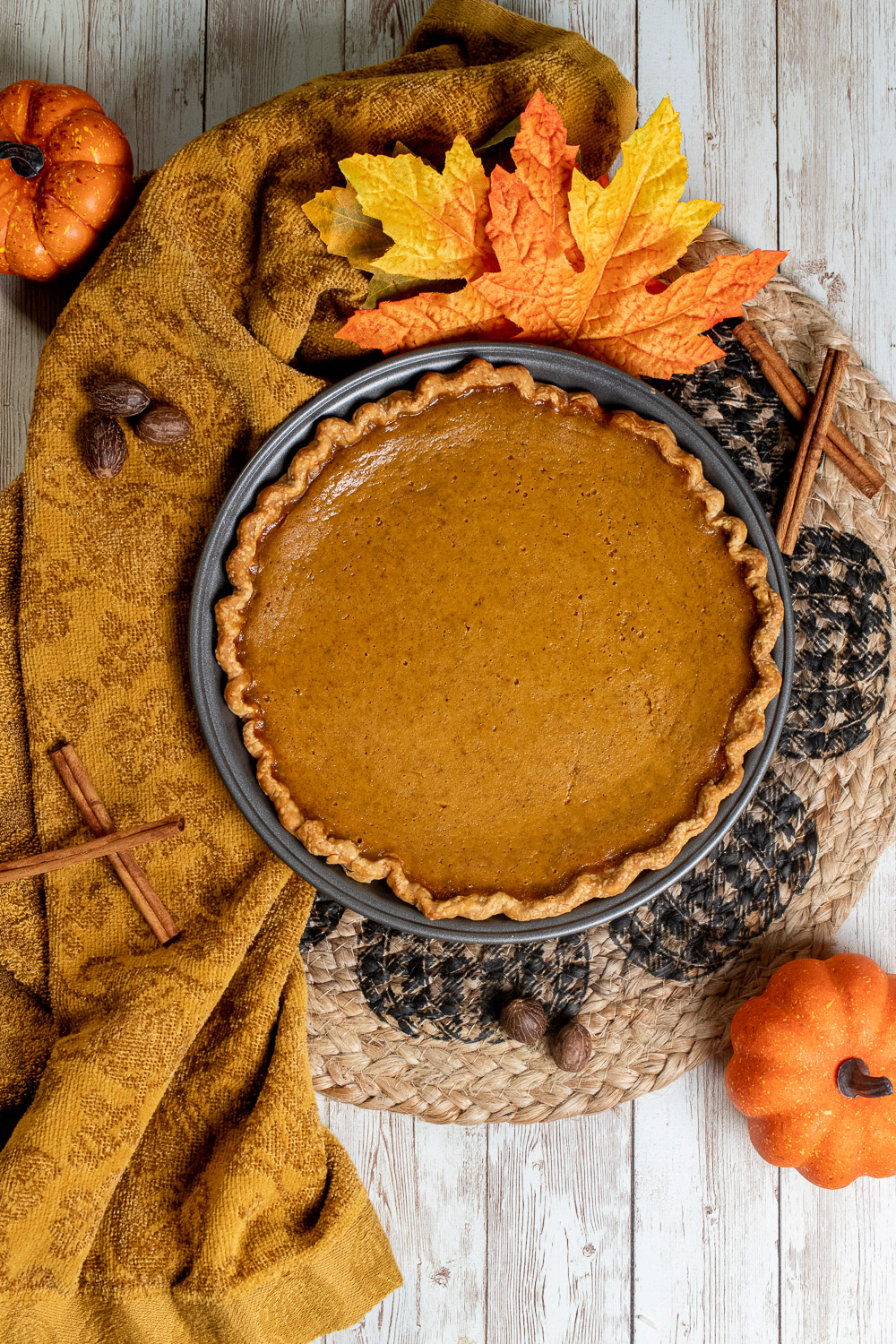 overhead view of classic pumpkin pie surrounded by fall decorations