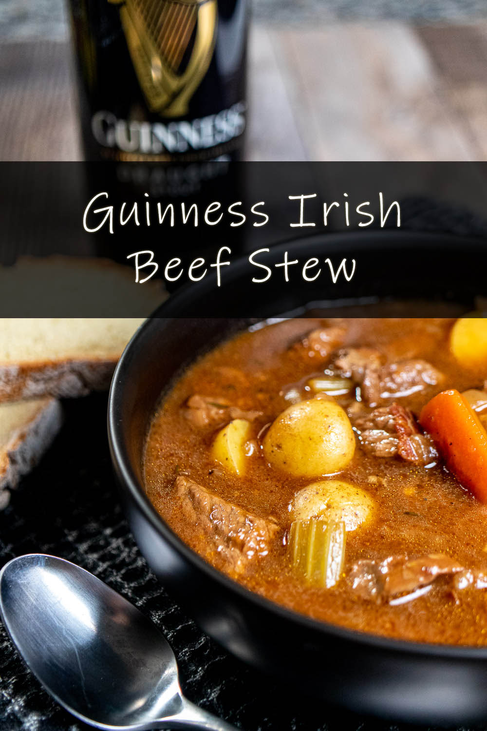 A black bowl of Guinness Irish stew served with Irish soda bread and a can of Guinness Draught behind it.