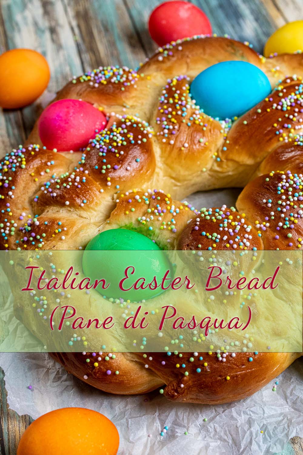 close up view of braided Italian Easter bread with dyed eggs and sprinkles