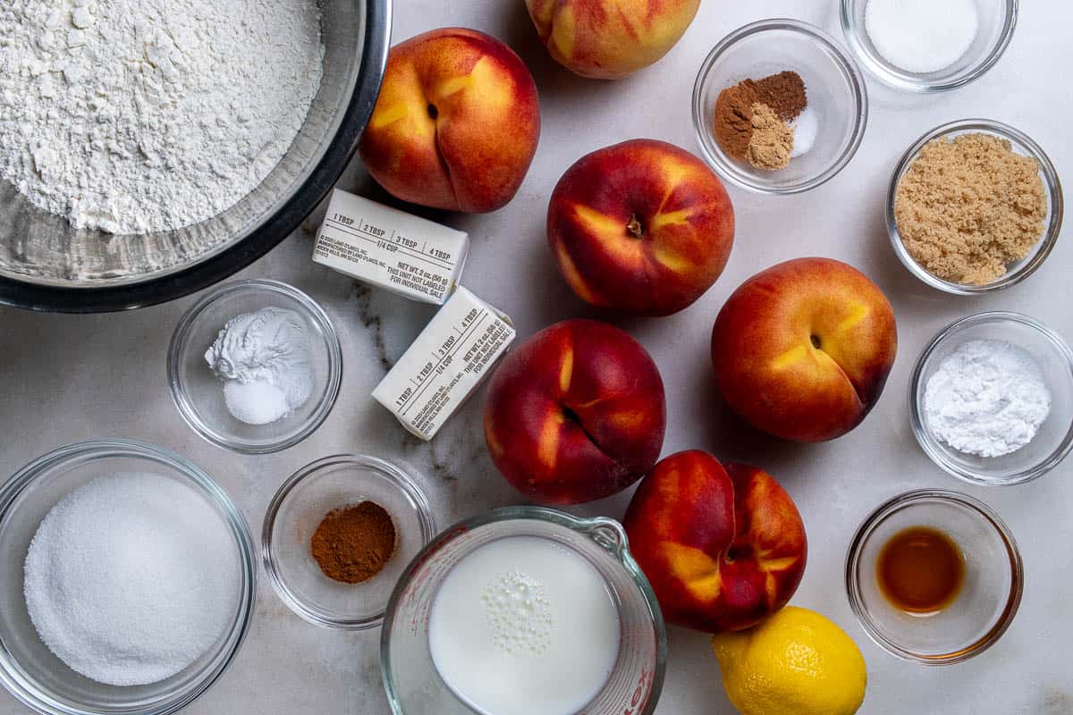 Ingredients for fresh peach cobbler with biscuit topping.