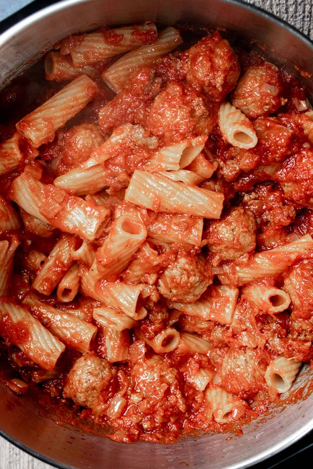 Once pasta is al dente, add the sauce and meats for baked rigatoni and stir together in pot.