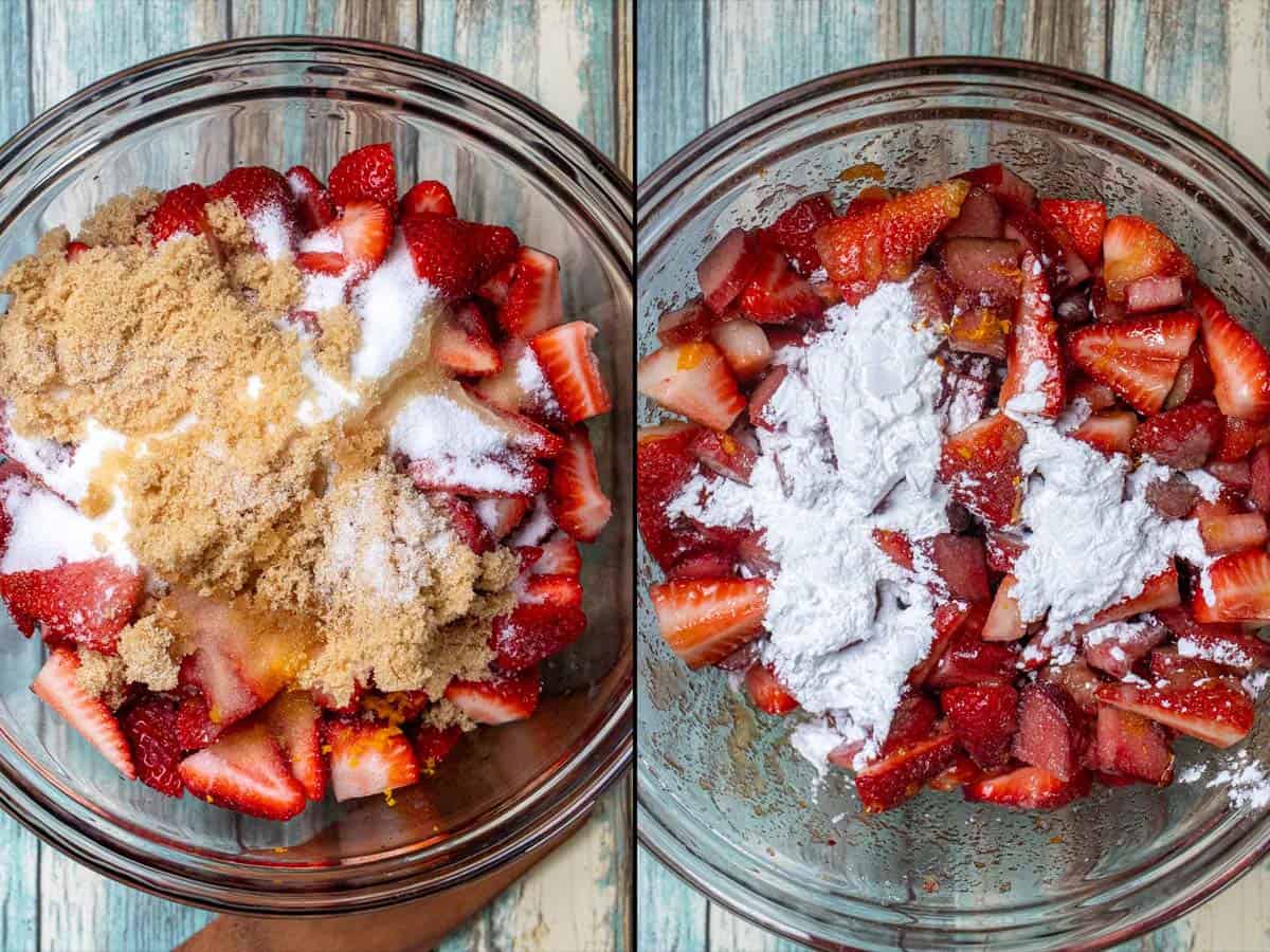 A glass mixing bowl filled with strawberries and rhubarb, covered with white and brown sugar and other ingredients for making pie filling.