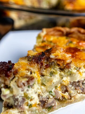 Close up of a slice of Hatch green chile quiche with breakfast sausage and Colby jack cheese.
