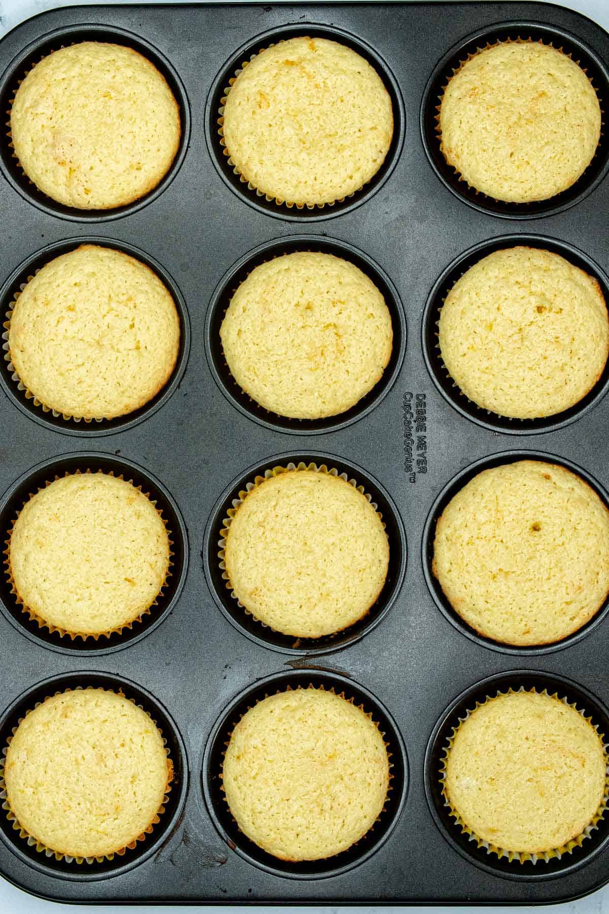 Baked Meyer lemon cupcakes in muffin tin.