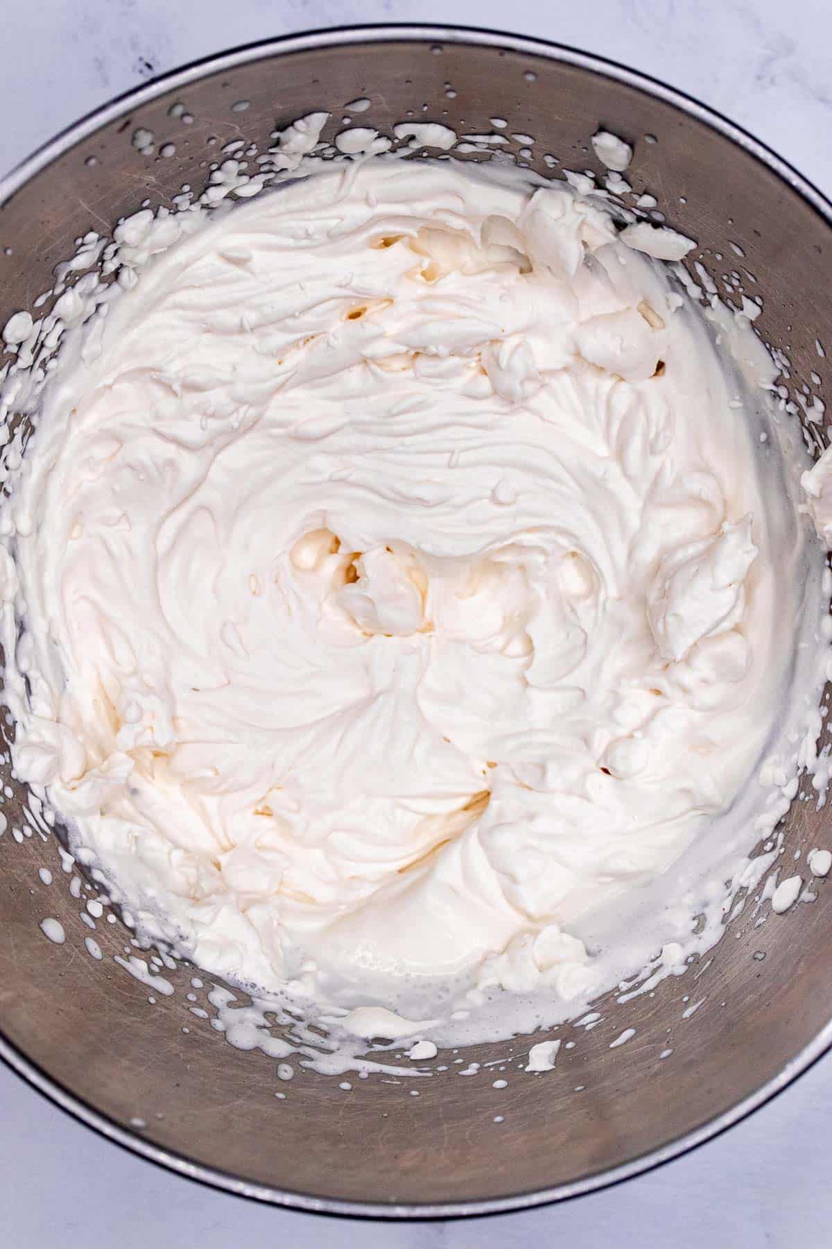 Homemade whipped cream with raspberry liqueur whipped to stiff peaks.