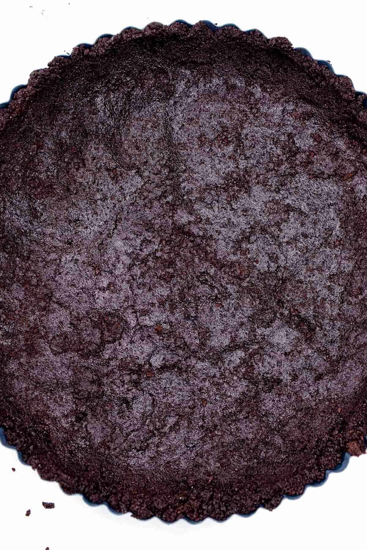 Oreo cookie crust pressed into a 9-inch tart pan.