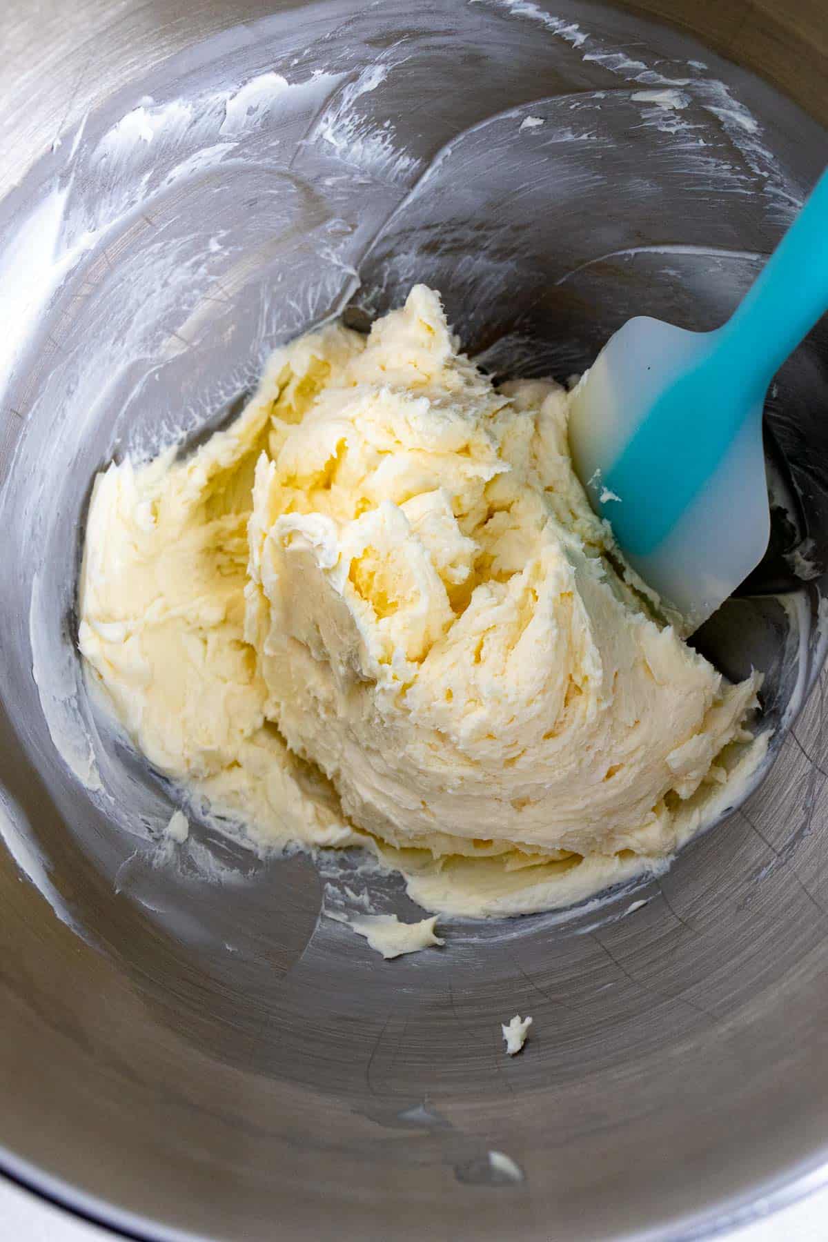 Butter, cream cheese, and sugar mixed together in bowl of a stand mixer.
