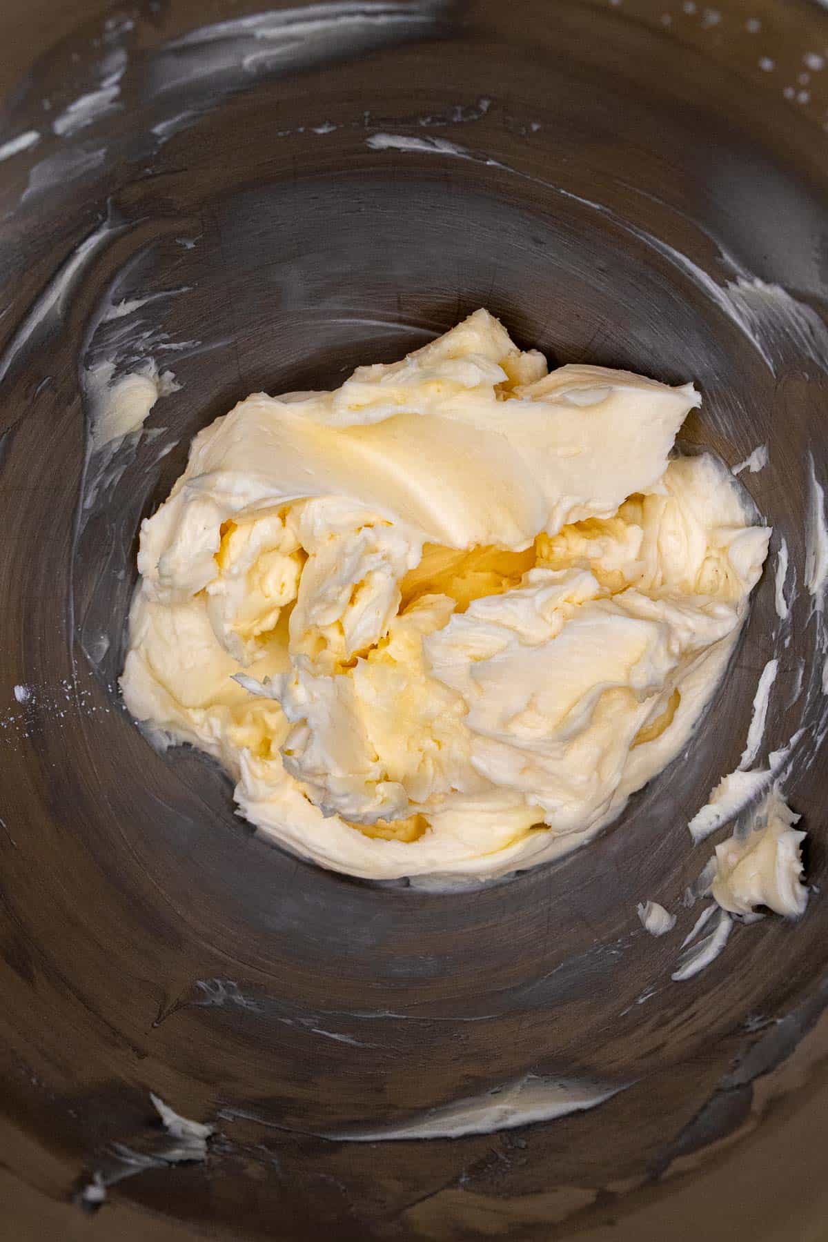 Butter and some of the powdered sugar for buttercream creamed together in bowl of stand mixer.