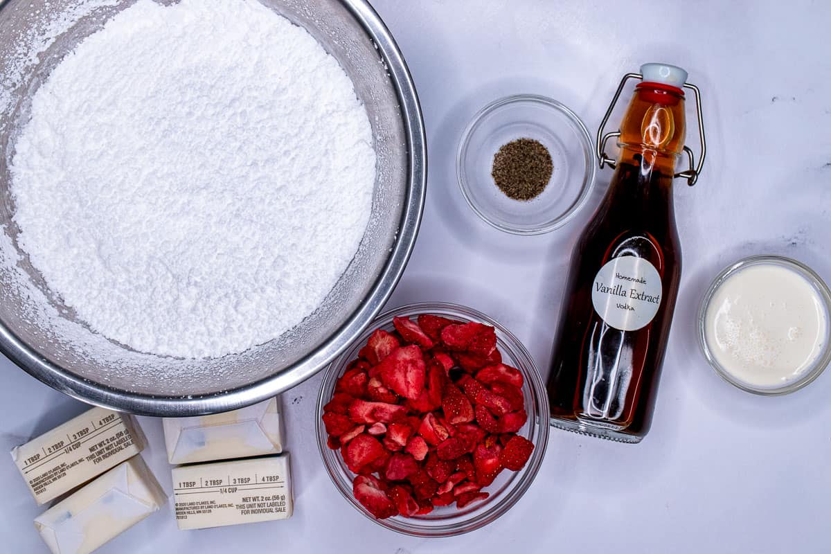 Ingredients for making strawberry buttercream frosting.