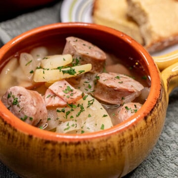 A bowl of soupy Dublin coddle with chunks of Irish sausage and potatoes.
