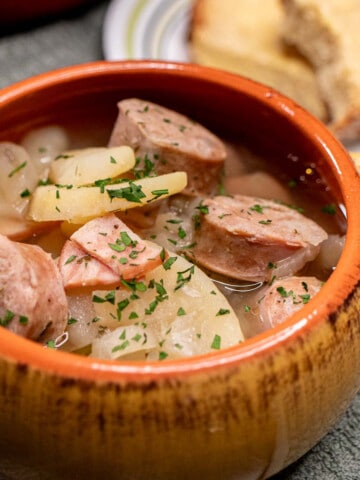 A bowl of soupy Dublin coddle with chunks of Irish sausage and potatoes.