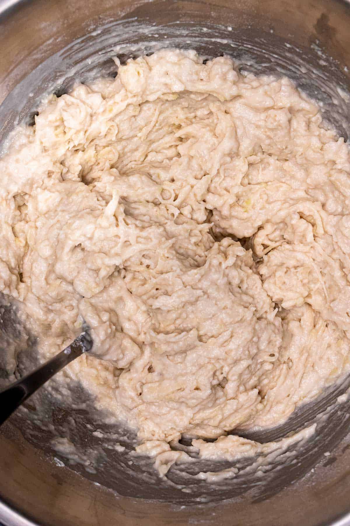 Adding buttermilk to the mashed potato mixture for making Irish potato pancakes.