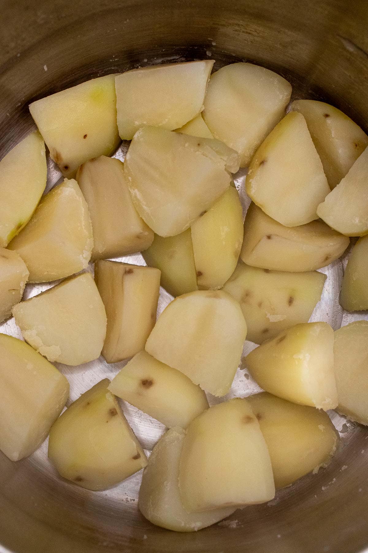 Parboiled potatoes drained and added back to pot to dry out some.