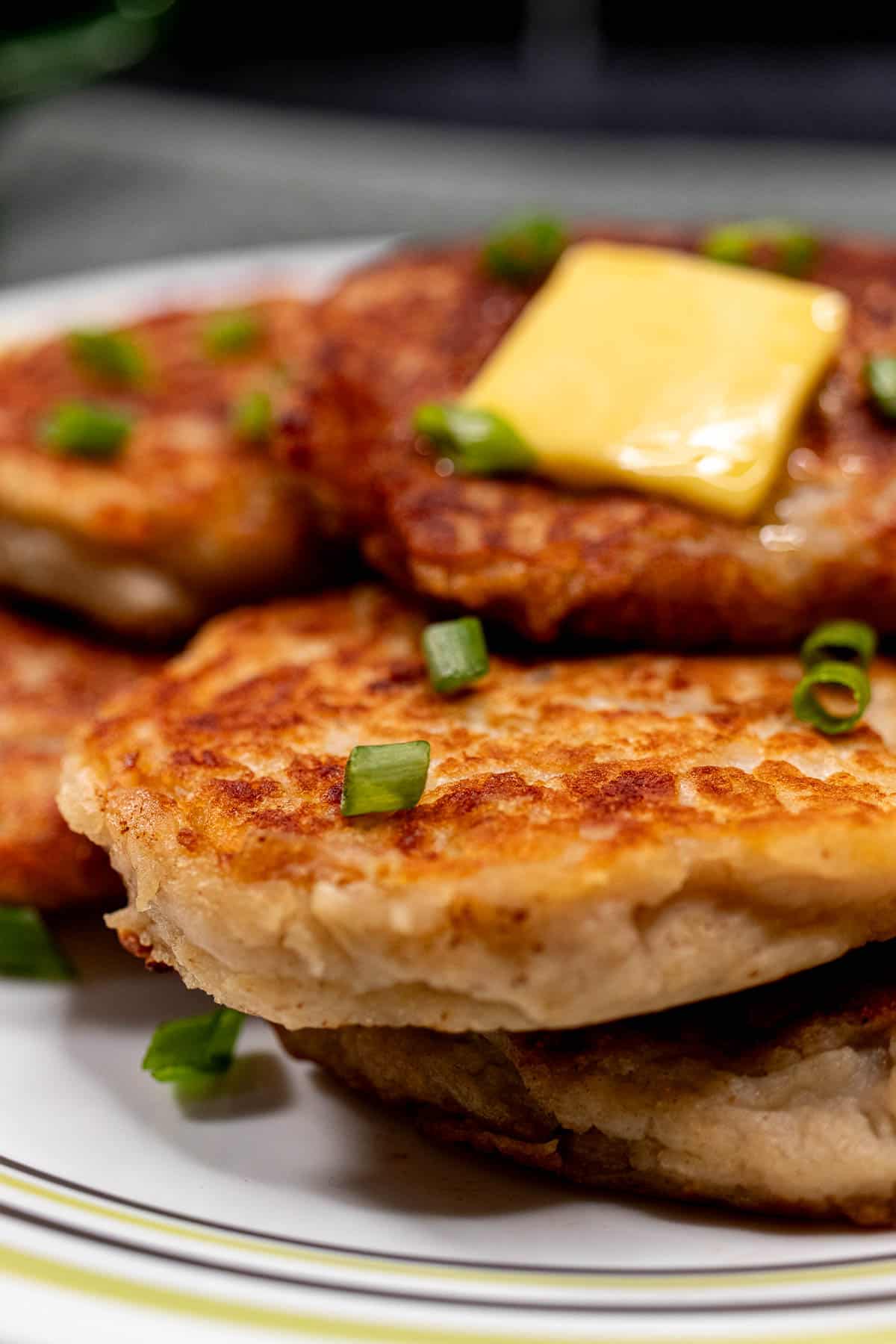 Close view of Irish boxty on a plate. Crispy hashbrown exterior with a soft looking center.