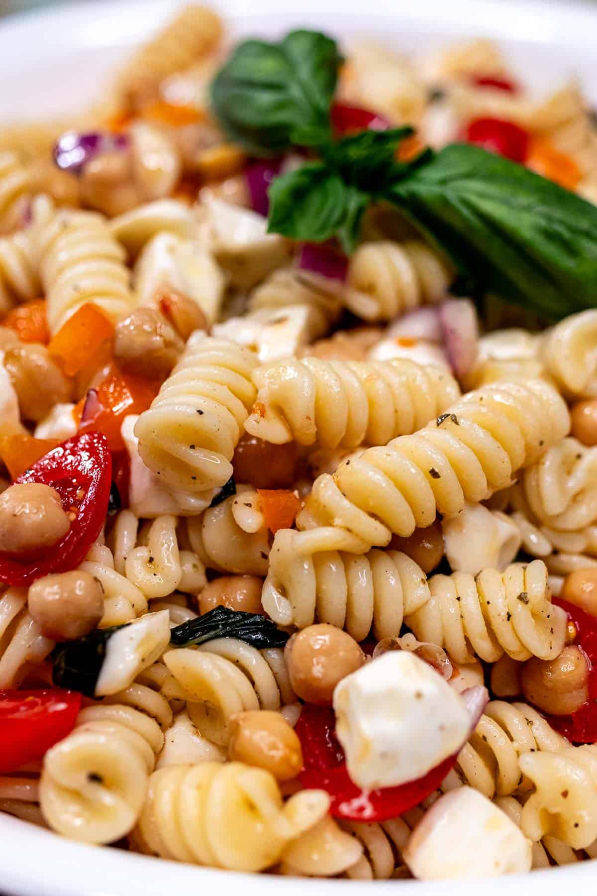 Close up of a bowl of summer pasta salad.
