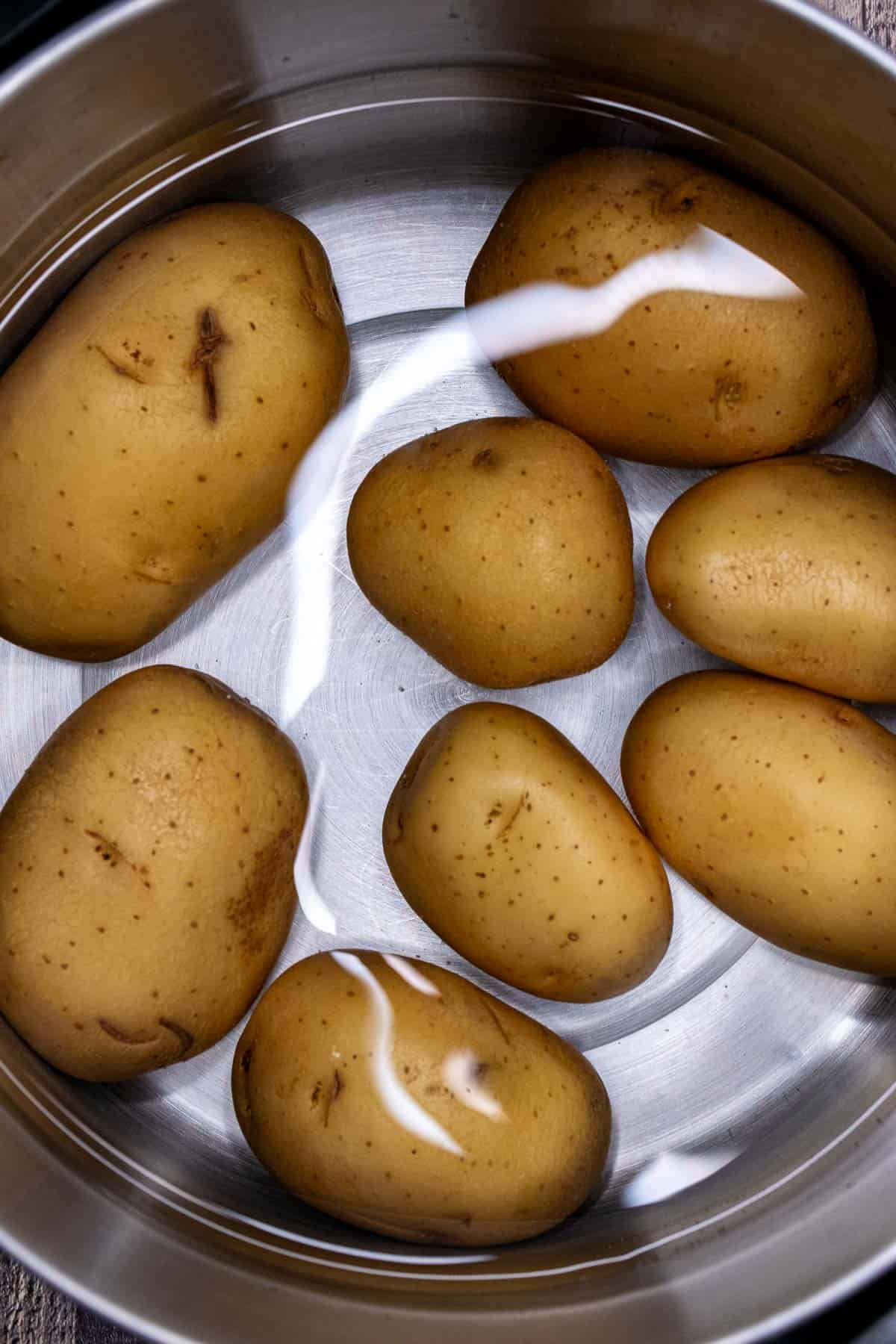 Unpeeled Yukon gold potatoes par boiled. 