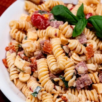 Large white serving bowl filled with a creamy, smoky pasta salad.