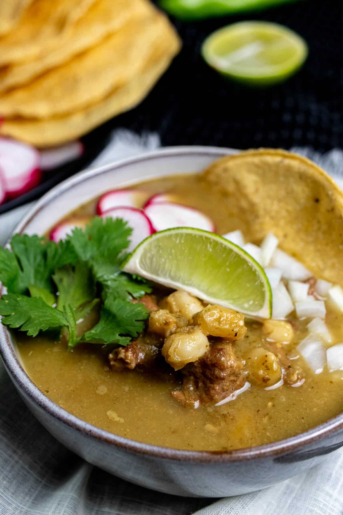 A bowl of New Mexican posole verde made with Hatch chiles.