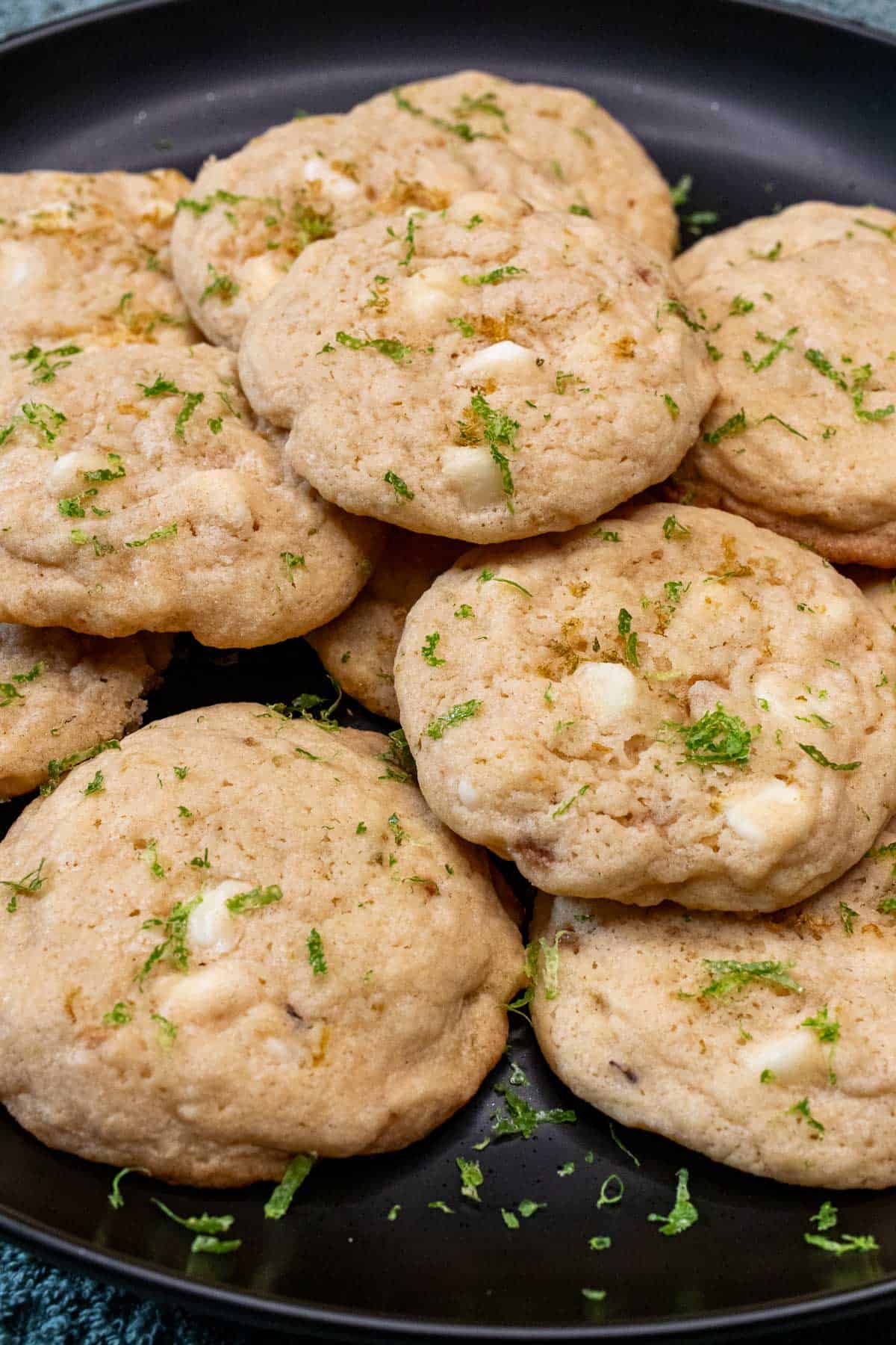 A plate of white chocolate key lime cookies dusted with key lime zest.