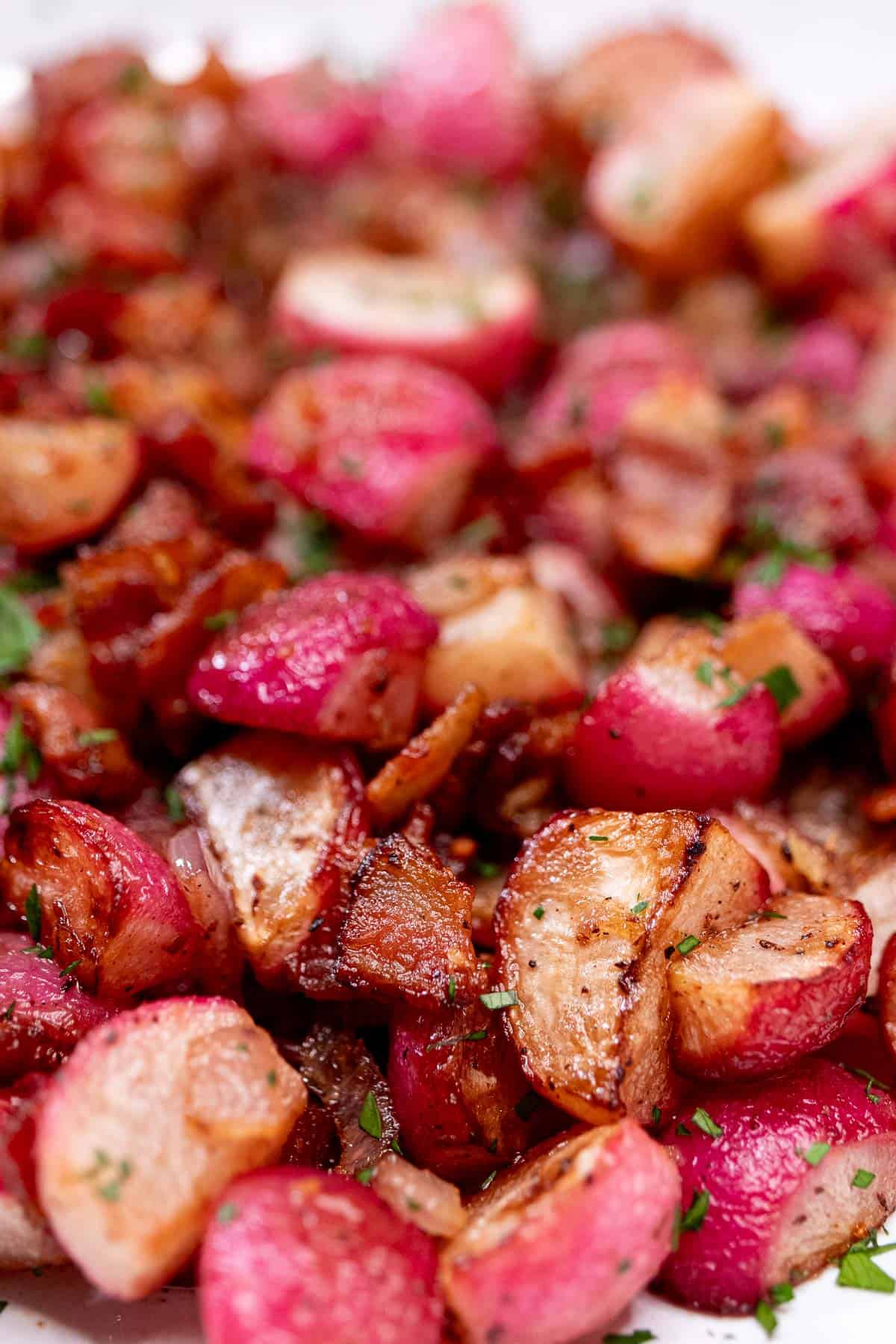 Roasted radishes served with bacon and shallot.