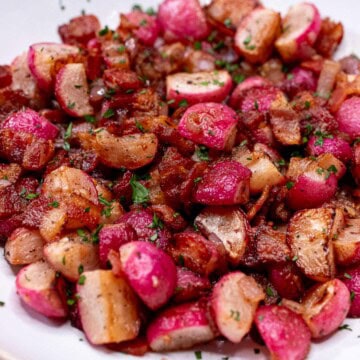 Sauteed radishes with bacon and shallots in a bowl.
