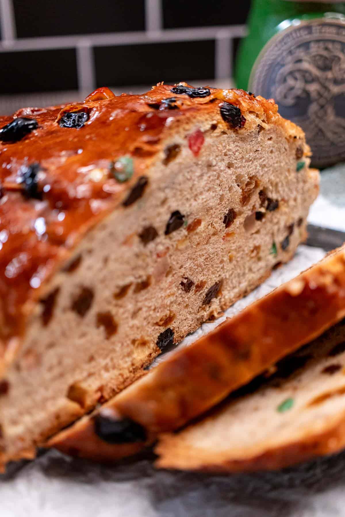 A partially sliced loaf of traditional Irish barmbrack.