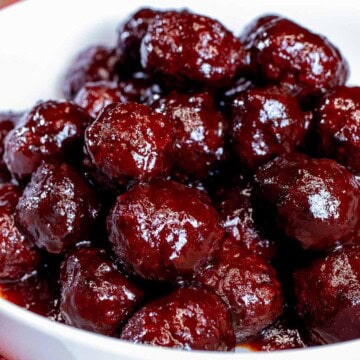 A serving bowl full of blackberry chipotle BBQ meatballs.