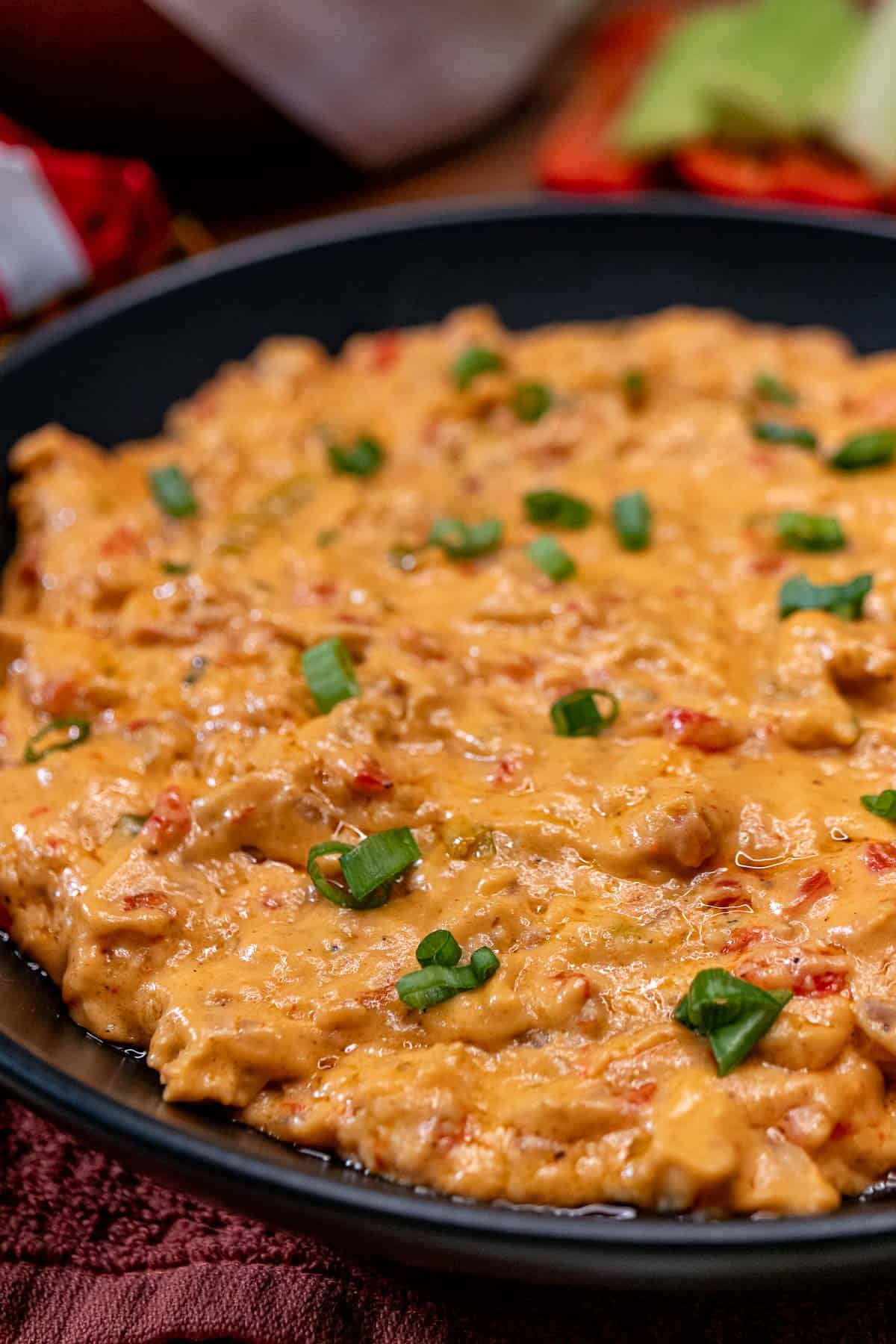 A large serving bowl filled with hot crawfish dip.