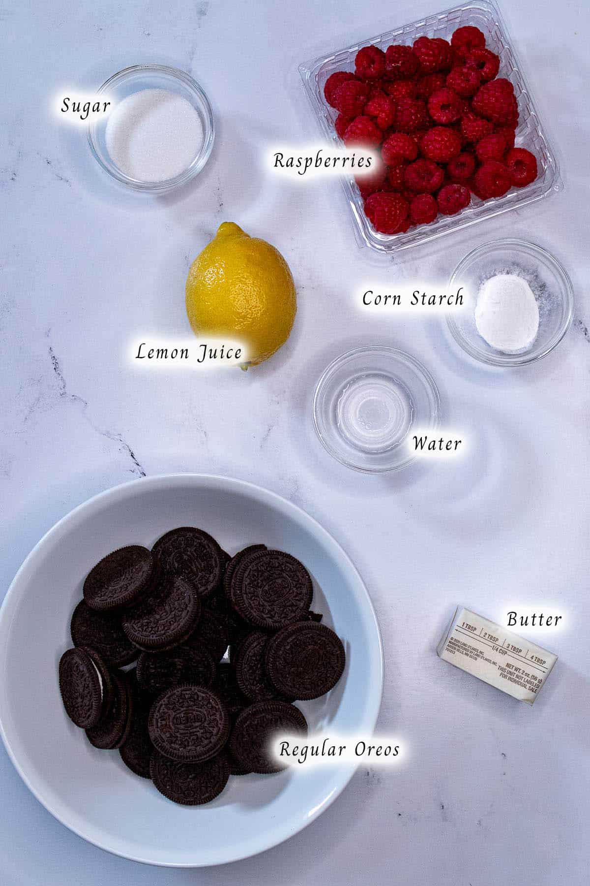 Ingredients for making raspberry sauce and a chocolate Oreo crust.