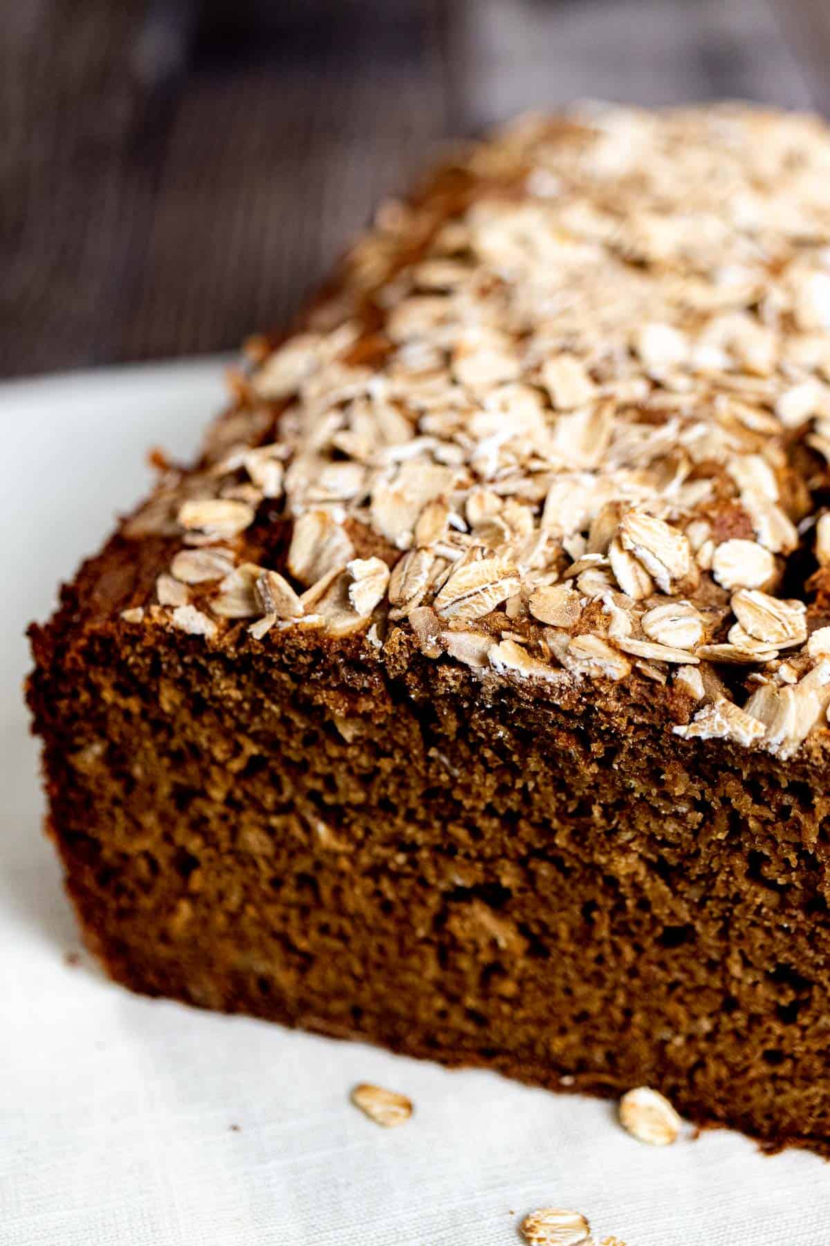 A loaf of Guinness brown bread topped with rolled oats.