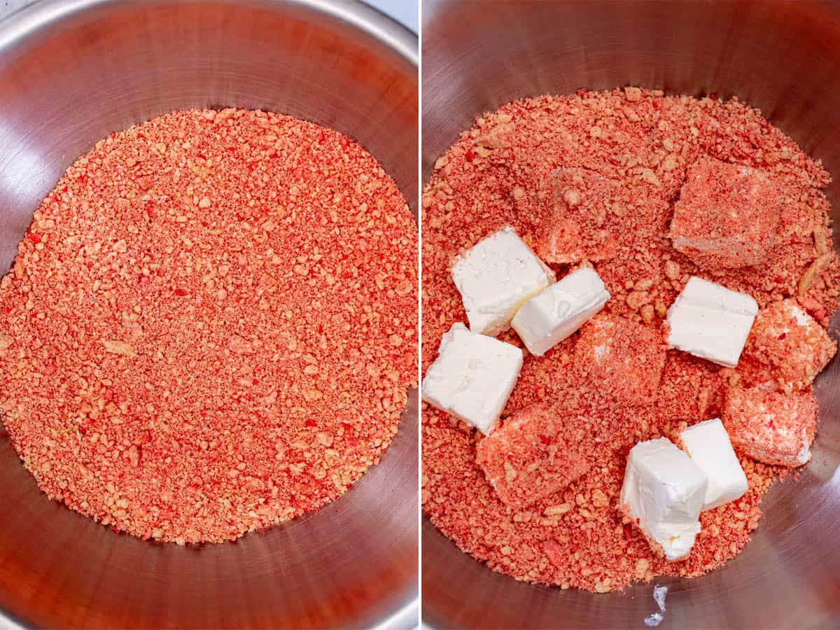 A mixing bowl with crushed Golden Oreos and freeze-dried strawberry powder, then cream cheese pieces added.
