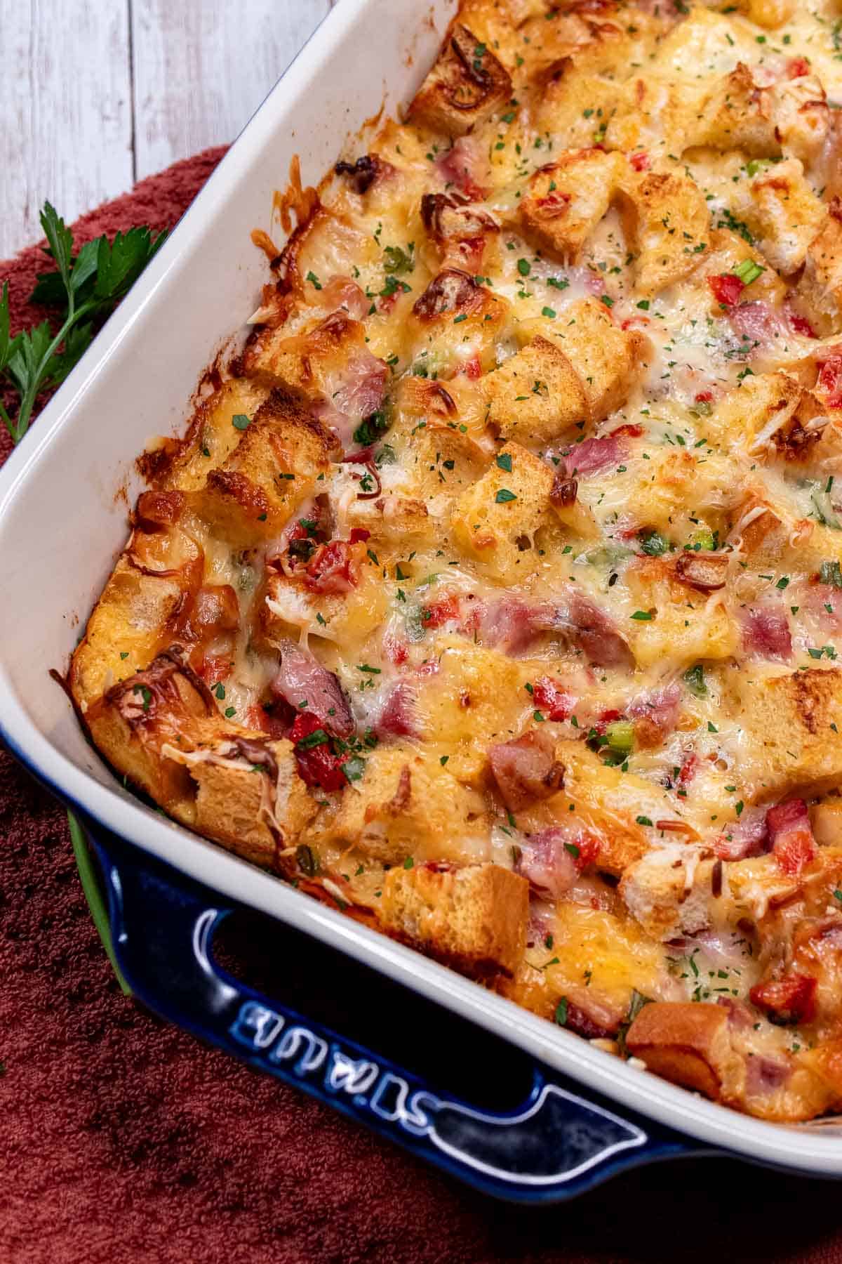 A baking dish full of overnight ham and cheese strata.