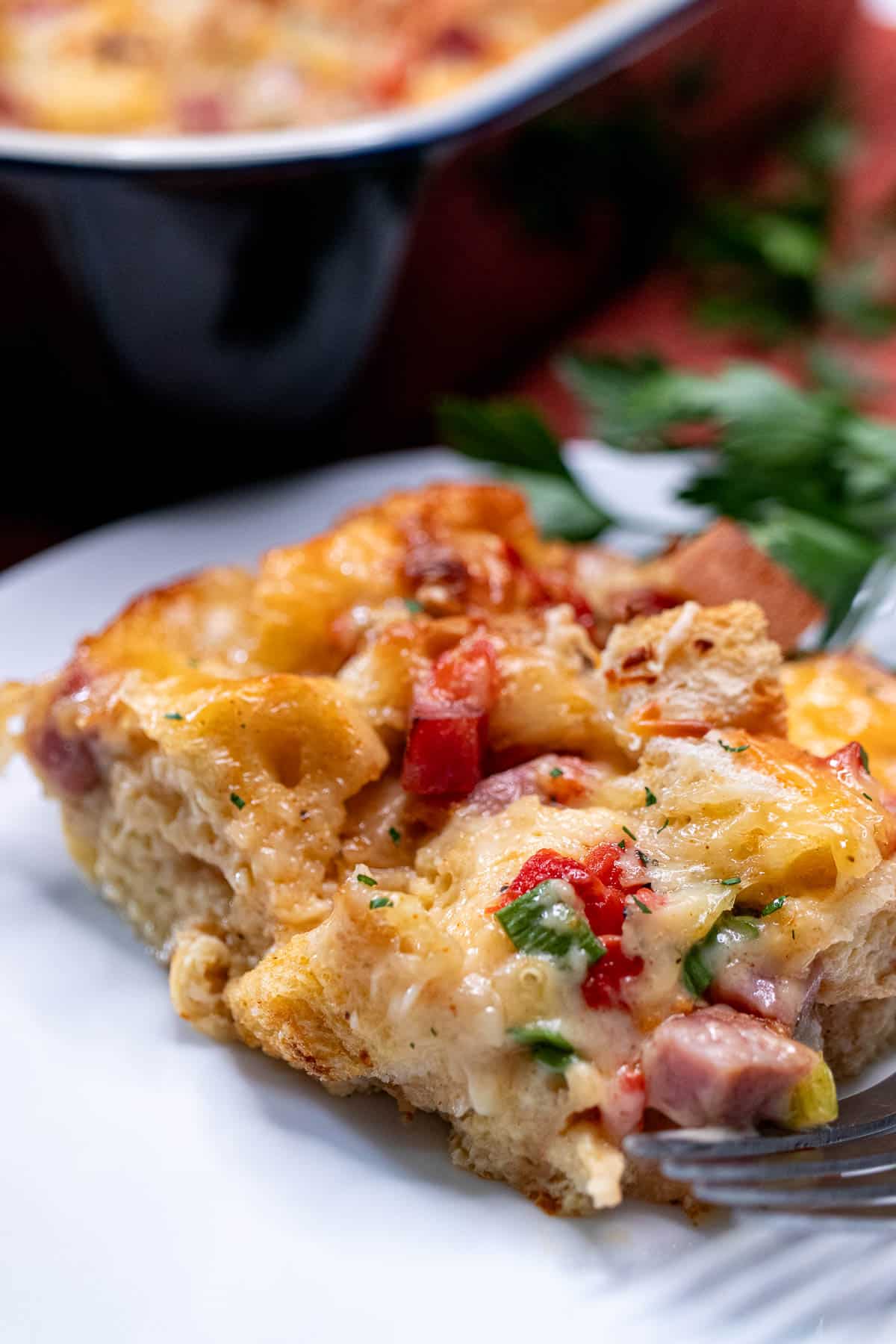 A portion of overnight ham and cheese strata on a plate.