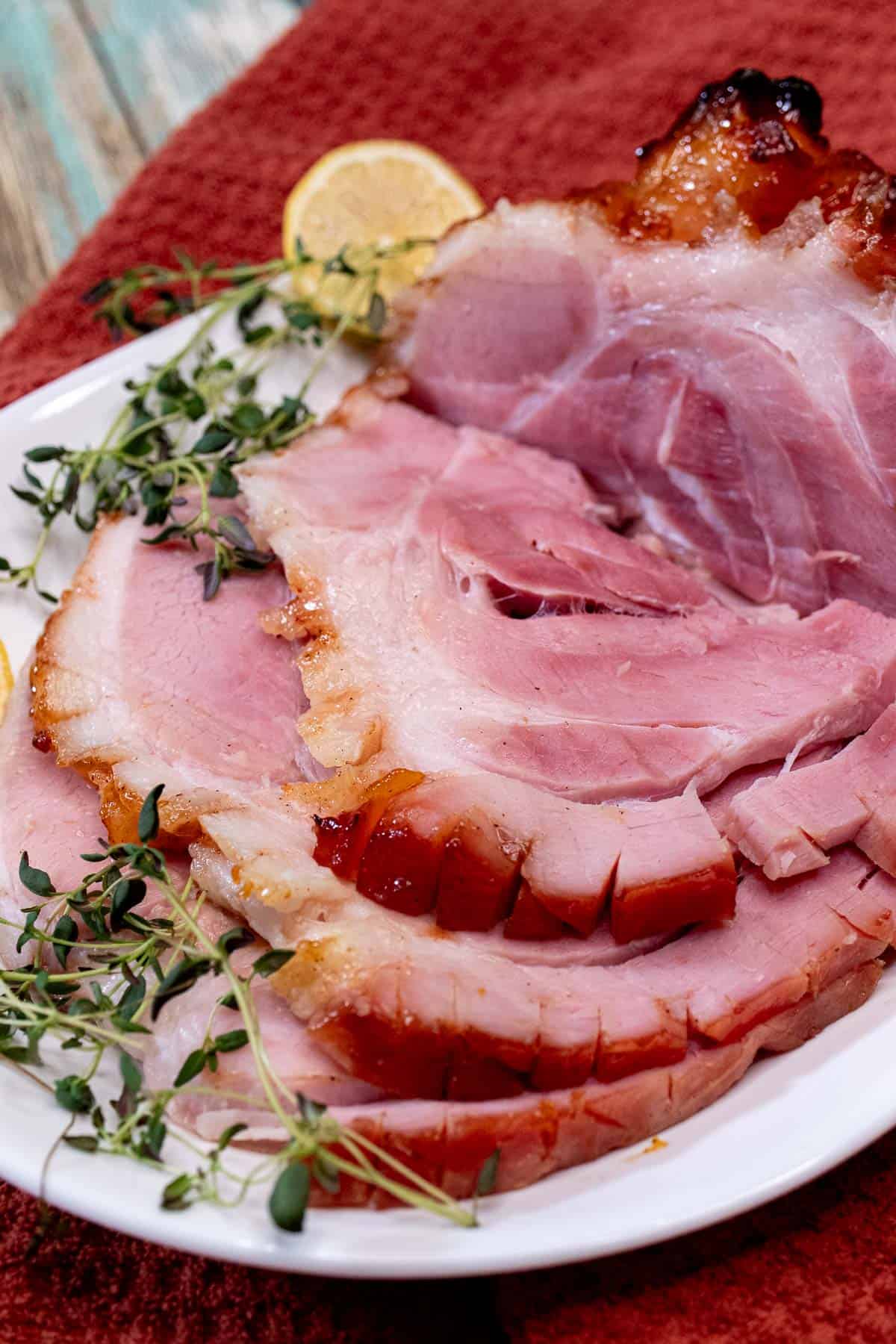 Partially carved peach & bourbon glazed baked ham.
