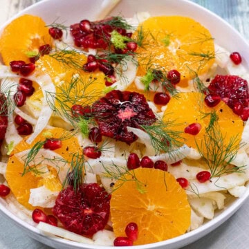 A bowl of Sicilian fennel and orange salad with pomegranate arils.