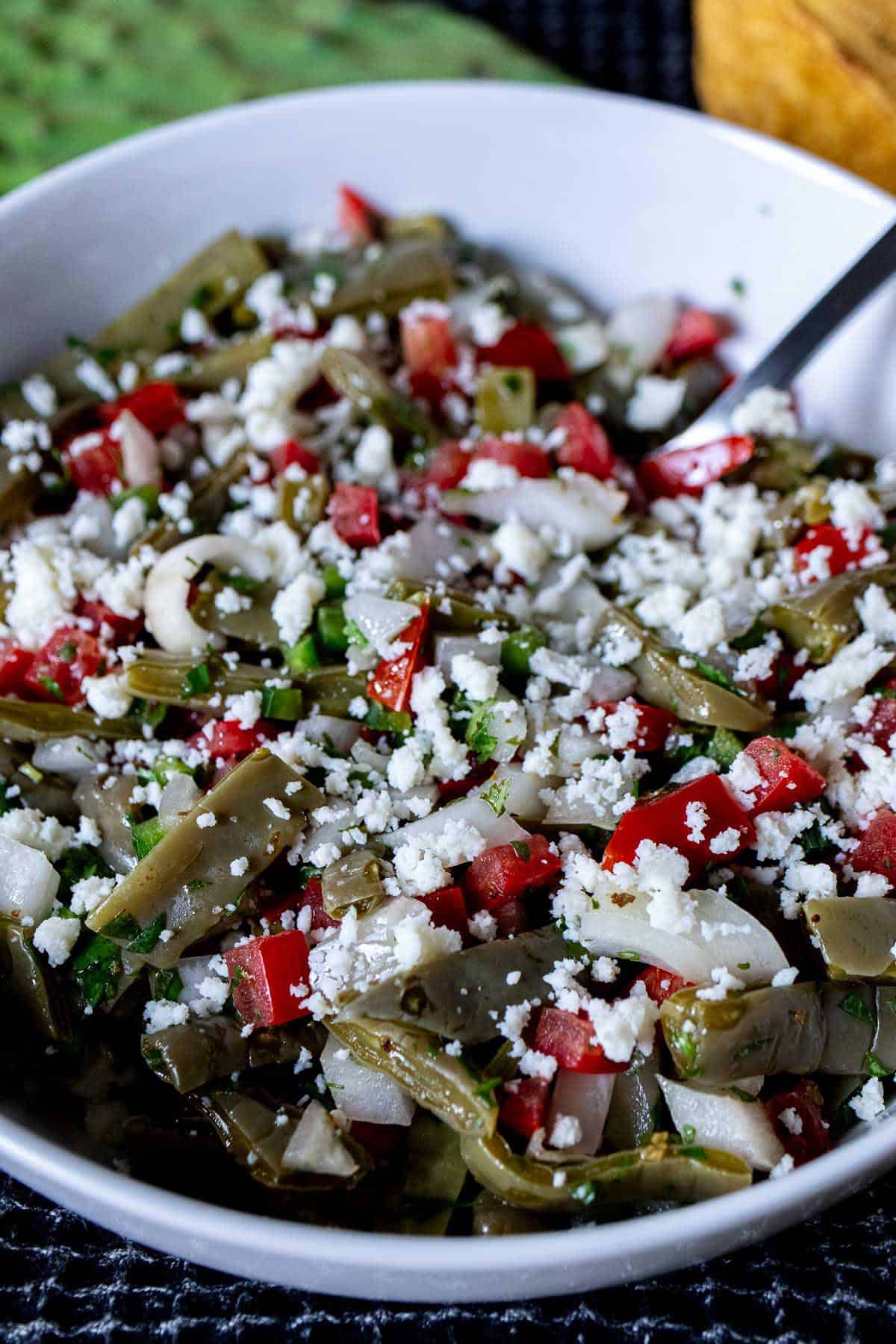 A large bowl filled with Mexican cactus salad.