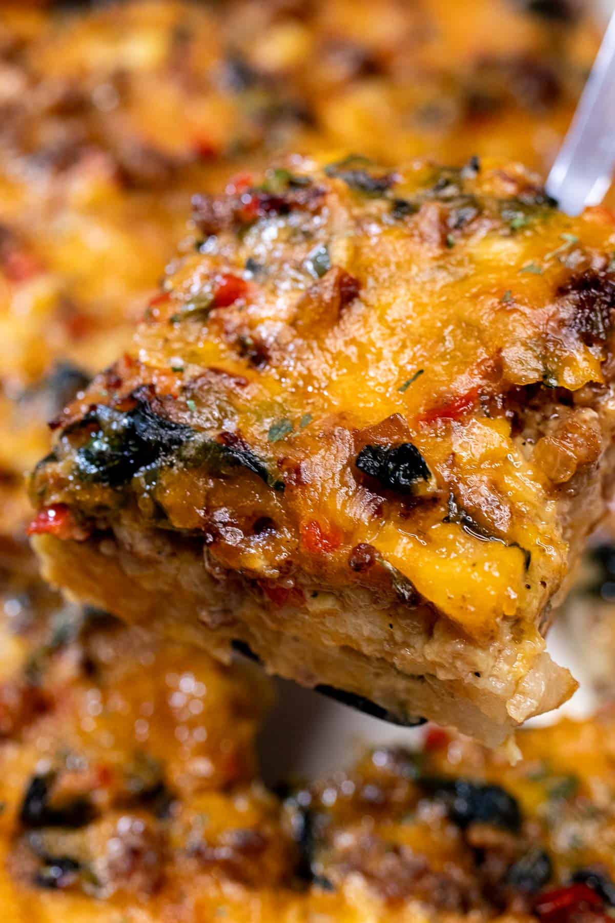 Removing a large slice of breakfast casserole from the baking dish.