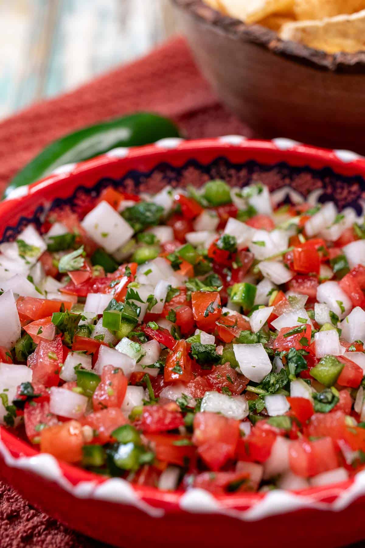 A red bowl full of classic pico de gallo.