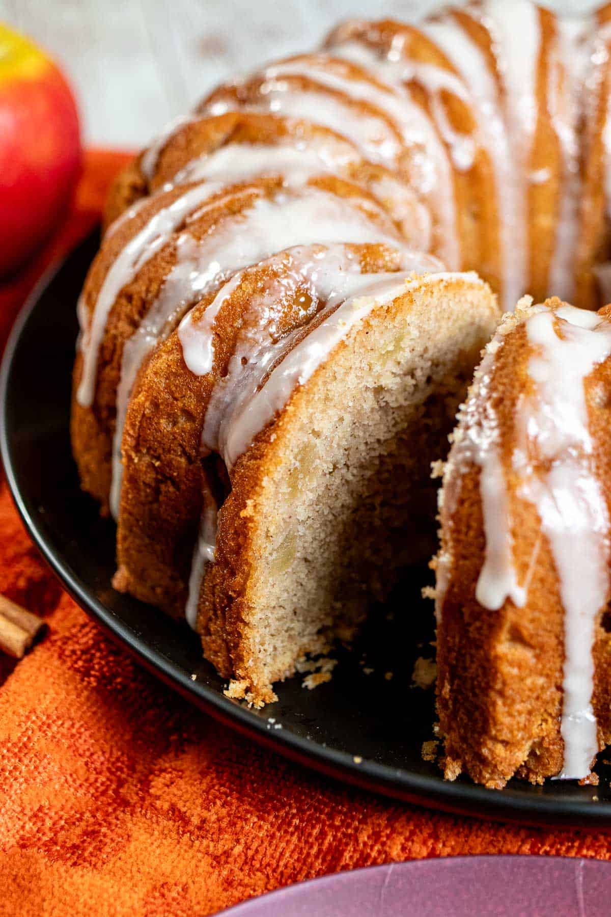 An apple cider Bundt cake with a slice removed.
