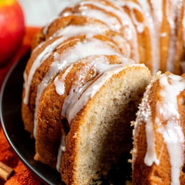 A cider-glazed apple Bundt cake with a slice removed.